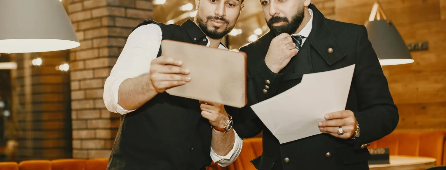 A learner and instructor going through a printed running order together