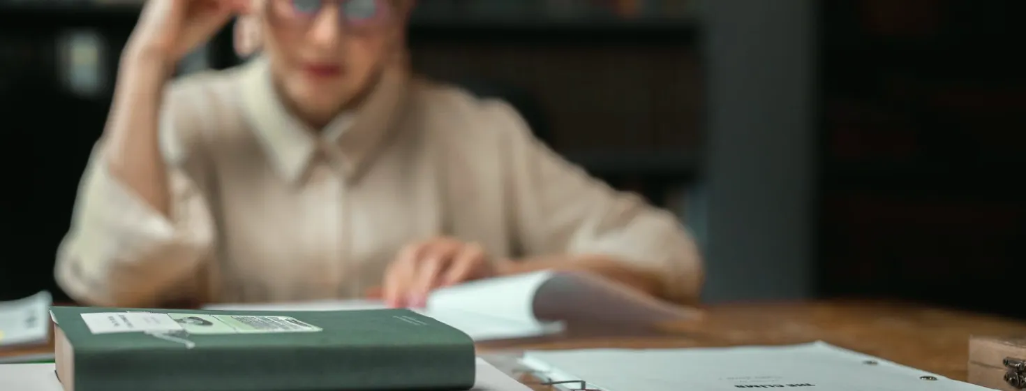 A learner timing a segment script with a stopwatch and marked-up schedule
